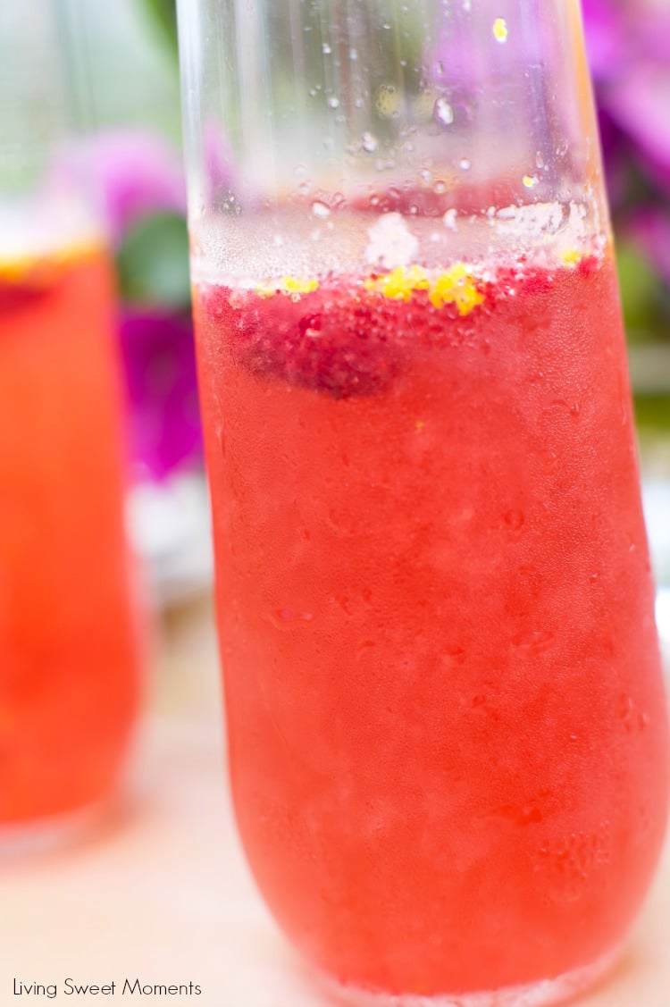 Orange raspberry sparkling wine cocktail: the ultimate summer cocktail! Combine cointreau with raspberry sorbet, fresh raspberries in a bubbly delicious drink. 