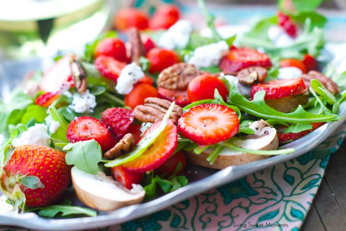 delicious Arugula salad topped with strawberries, goat cheese and toasted pecans then drizzled with a simple vinaigrette