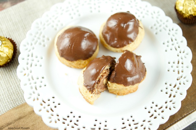 This Ferrero stuffed hazelnut cookies are topped with melted chocolate. The perfect crispy cookie recipe that will wow a crowd. Best dessert ever! Yum