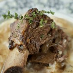 Slow Cooker Short Ribs - Made with red wine and delightful herbs. This delicious dish falls off the bone creating tender flavorful beef that requires very little prep.