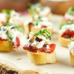 Roasted Red Pepper Burrata Crostini - crispy baguette slices are topped with roasted red peppers, creamy burrata, basil and a splash of balsamic glaze.