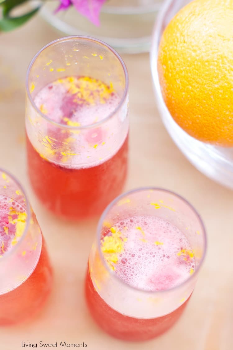 Orange raspberry sparkling wine cocktail: the ultimate summer cocktail! Combine cointreau with raspberry sorbet, fresh raspberries in a bubbly delicious drink. 