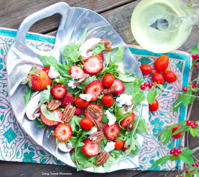 delicious Arugula salad topped with strawberries, goat cheese and toasted pecans then drizzled with a simple vinaigrette