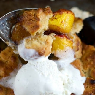 Skillet Peach Cobbler: This easy dessert recipe is delicious, easy and whips up in minutes. Peaches are cooked first on the stove and then baked in the oven