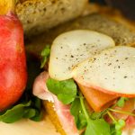 Open Faced Ham And Cheese Sandwich - delicious sandwich with goat cheese, pears, guava, watercress and ham topped with sweet honey. Easy, elegant and tasty!