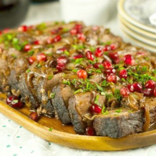 Wine And Pomegranate Brisket Recipe: delicious braised brisket with a pomegranate and wine sauce. Perfect & easy beef dinner for parties and entertaining.