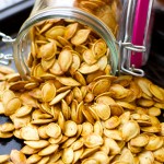 Roasted Pumpkin Seeds - don't know what to do with the seeds after you carve that pumpkin? Create a a healthy crunchy snack with the seeds. Easy and delish!