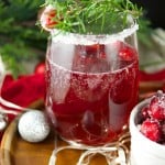 This delicious Holiday Cranberry Mocktail is infused with rosemary and cranberry syrup. Topped with a fizzy lime soda! The perfect drink for Holiday parties