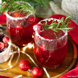 This delicious Holiday Cranberry Mocktail is infused with rosemary and cranberry syrup. Topped with a fizzy lime soda! The perfect drink for Holiday parties