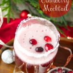 This delicious Holiday Cranberry Mocktail is infused with rosemary and cranberry syrup. Topped with a fizzy lime soda! The perfect drink for Holiday parties