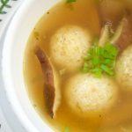 This Asian style Matzo Ball Soup recipe is made with a flavorful ginger scallion broth and shiitake mushrooms. Perfect for your modern Passover Seder menu.