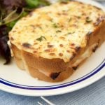 These Croque Monsieur Baked sandwiches are filled ham and cheese and topped with bechamel sauce and gruyere cheese. An easy recipe for dinner or brunch.