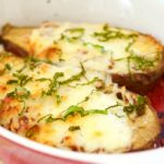 This delicious Cheesy Stuffed Eggplant Recipe is easy to make, vegetarian and very cheesy. The eggplant is roasted for extra flavor. Perfect as a side dish.