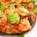 This delicious Shrimp Stuffed Eggplant Recipe is easy to make and is perfect for a nice weeknight dinner idea. The filling is inspired by Italian Caponata