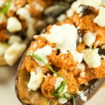 This tasty Greek Stuffed Eggplant is made with meat, kalamata olives and topped with feta cheese and tzatziki sauce. The perfect quick weeknight dinner idea