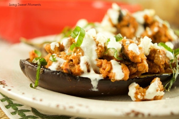 This tasty Greek Stuffed Eggplant is made with meat, kalamata olives and topped with feta cheese and tzatziki sauce. The perfect quick weeknight dinner idea