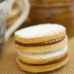 Alfajores Recipe - they are delicate shortbread cookies filled with dulce de leche. These cookies use cornstarch as a main ingredient. Great with coffee!