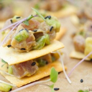 This delicious tuna tartare recipe is made with avocado and dressed in an Asian sauce. The perfect healthy appetizer served on top of a cracker.