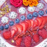 This delicious acai bowl recipe is blended with berries, dragonfruit, and yogurt. It's topped with fresh fruit and nuts. A healthy and quick breakfast idea.