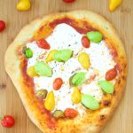 This delicious burrata pizza recipe is made with homemade pizza dough and is topped with sauce, summer tomatoes, and burrata cheese. Great for entertaining!