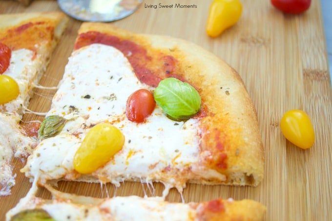 This delicious burrata pizza recipe is made with homemade pizza dough and is topped with sauce, summer tomatoes, and burrata cheese. Great for entertaining!