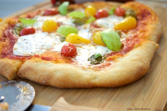 This delicious burrata pizza recipe is made with homemade pizza dough and is topped with sauce, summer tomatoes, and burrata cheese. Great for entertaining!