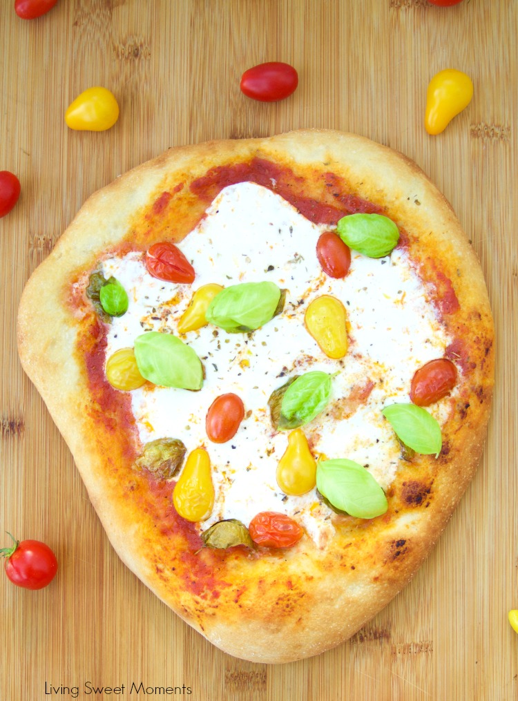 This delicious burrata pizza recipe is made with homemade pizza dough and is topped with sauce, summer tomatoes, and burrata cheese. Great for entertaining!