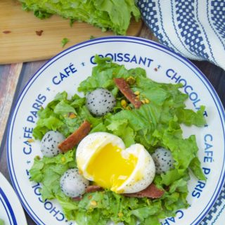 This amazing French Lyonnaise Salad Recipe is easy to make & delicious. Enjoy greens, bacon & fruit tossed with a mustard vinaigrette & a soft boiled egg.
