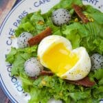 This amazing French Lyonnaise Salad Recipe is easy to make & delicious. Enjoy greens, bacon & fruit tossed with a mustard vinaigrette & a soft boiled egg.