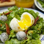 This amazing French Lyonnaise Salad Recipe is easy to make & delicious. Enjoy greens, bacon & fruit tossed with a mustard vinaigrette & a soft boiled egg.