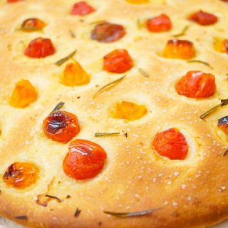 This delicious focaccia recipe is made under an hour and is flavored with cherry tomatoes and rosemary. It makes a wonderful appetizer to parties or dinners