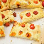 This delicious focaccia recipe is made under an hour and is flavored with cherry tomatoes and rosemary. It makes a wonderful appetizer to parties or dinners