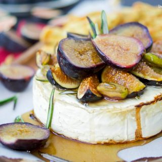This delicious baked brie recipe is topped with roasted figs, honey, rosemary, and pistachios. The perfect easy appetizer that's ready in 25 minutes or less