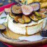 This delicious baked brie recipe is topped with roasted figs, honey, rosemary, and pistachios. The perfect easy appetizer that's ready in 25 minutes or less