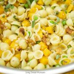 This creamy Mac And Cheese recipe is inspired by fall featuring butternut squash, peas, sage, and walnuts. The perfect easy 30-minute weeknight dinner idea. Vegetarian too!