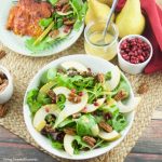 This tasty pomegranate Pear Salad is served with candied pecans and drizzled with a mustard dressing. The perfect autumn quick salad to serve with dinner.