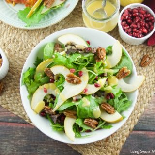 This tasty pomegranate Pear Salad is served with candied pecans and drizzled with a mustard dressing. The perfect autumn quick salad to serve with dinner.