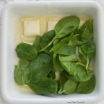 This delicious Ravioli Lasagna recipe is made with frozen ravioli, homemade Alfredo sauce, cheese and fresh spinach. The perfect quick weeknight dinner idea