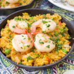 This delicious Spanish Shrimp With Yellow Rice recipe is super easy to make, ready in less than an hour, & feeds a crowd. Perfect for dinner or entertaining