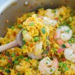 This delicious Spanish Shrimp With Yellow Rice recipe is super easy to make, ready in less than an hour, & feeds a crowd. Perfect for dinner or entertaining