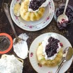 These moist Mini Bundt Cakes are made with confetti sprinkles and served with whipped cream and homemade blueberry compote. Perfect as an elegant dessert.