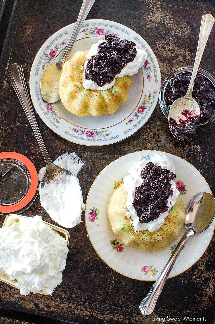 These moist Mini Bundt Cakes are made with confetti sprinkles and served with whipped cream and homemade blueberry compote. Perfect as an elegant dessert.