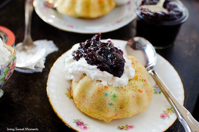 These moist Mini Bundt Cakes are made with confetti sprinkles and served with whipped cream and homemade blueberry compote. Perfect as an elegant dessert.