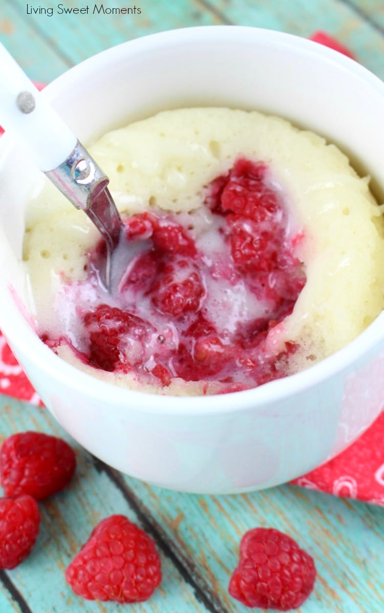 This moist and delicious Raspberry Sour Cream Mug Cake recipe is ready in 4 minutes or less and is topped with a yummy Vanilla Glaze. A quick dessert idea