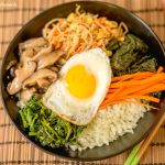 This amazing Korean Cauliflower Bibimbap recipe is delicious, low-carb, keto friendly, and easy to make. The perfect quick vegetarian weeknight dinner idea. Closeup of the bowl with fried egg