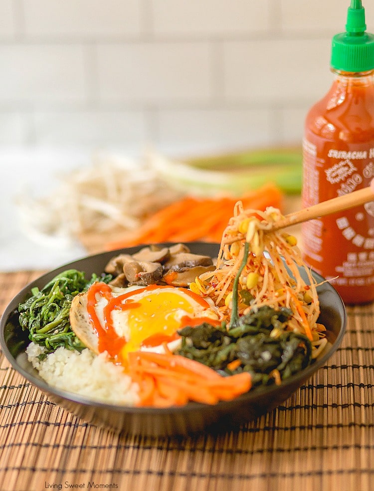 This amazing Korean Cauliflower Bibimbap recipe is delicious, low-carb, keto friendly, and easy to make. The perfect quick vegetarian weeknight dinner idea. Chopsticks holding bean sprouts