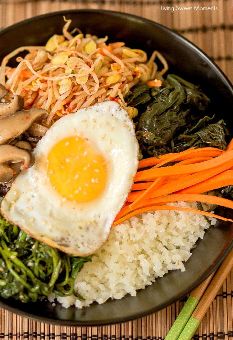 This amazing Korean Cauliflower Bibimbap recipe is delicious, low-carb, keto friendly, and easy to make. The perfect quick vegetarian weeknight dinner idea. Vertical closeup of the black bowl