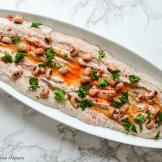 Entertain in style! This savory Black Eyed Pea Hummus recipe is the perfect appetizer to serve with pita chips and crackers. A delicious flavorful spread. White long dish