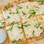 This keto friendly Cauliflower Pizza Crust is crispy, delicious, low-carb, and super easy to make. Top with your favorite sauce and veggies & it'll be a hit