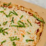 This keto friendly Cauliflower Pizza Crust is crispy, delicious, low-carb, and super easy to make. Top with your favorite sauce and veggies & it'll be a hit